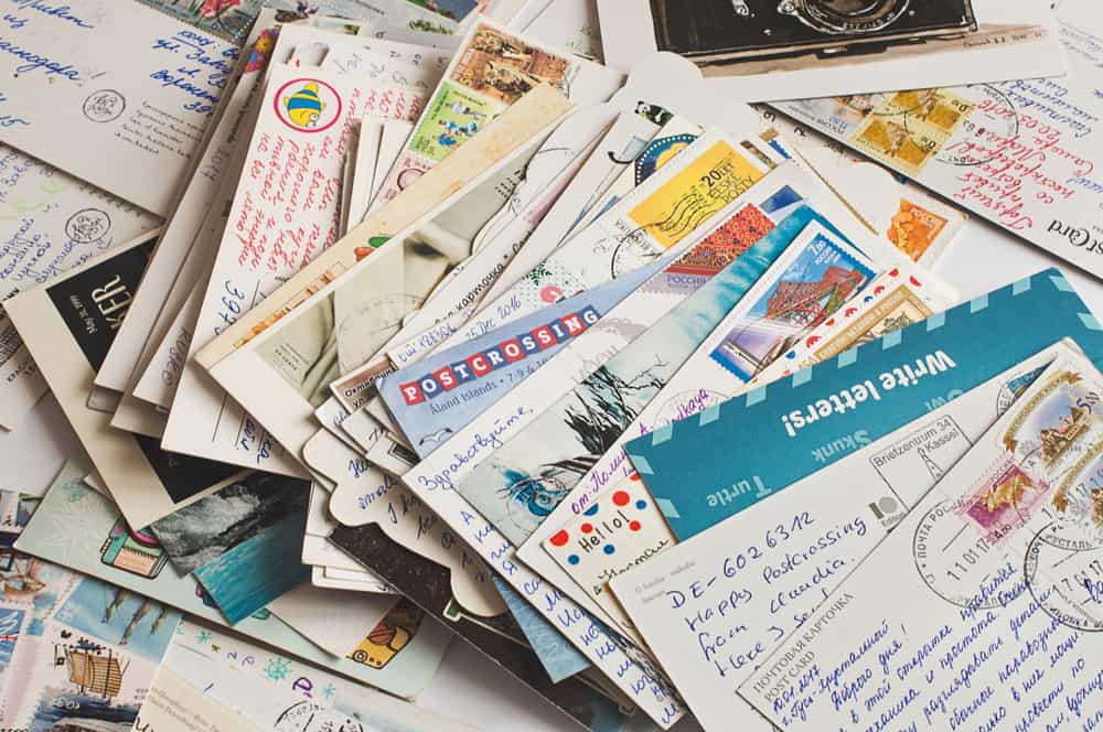 Even today, people enjoy writing letters on postcards. Photo Credit: Valentina Perfilyeva/Shutterstock