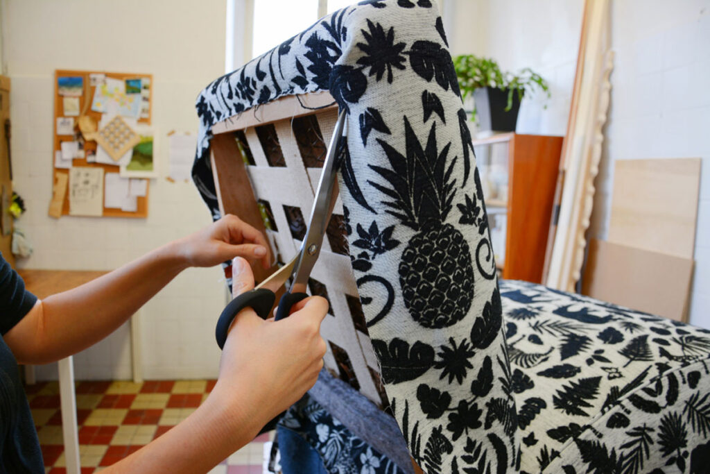 Homeguide Upholsterer Recovering Antique Chair And Cutting Fabric