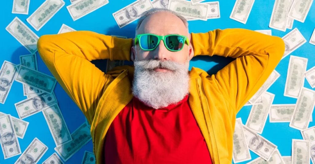 Man With White Beard Lying On Money