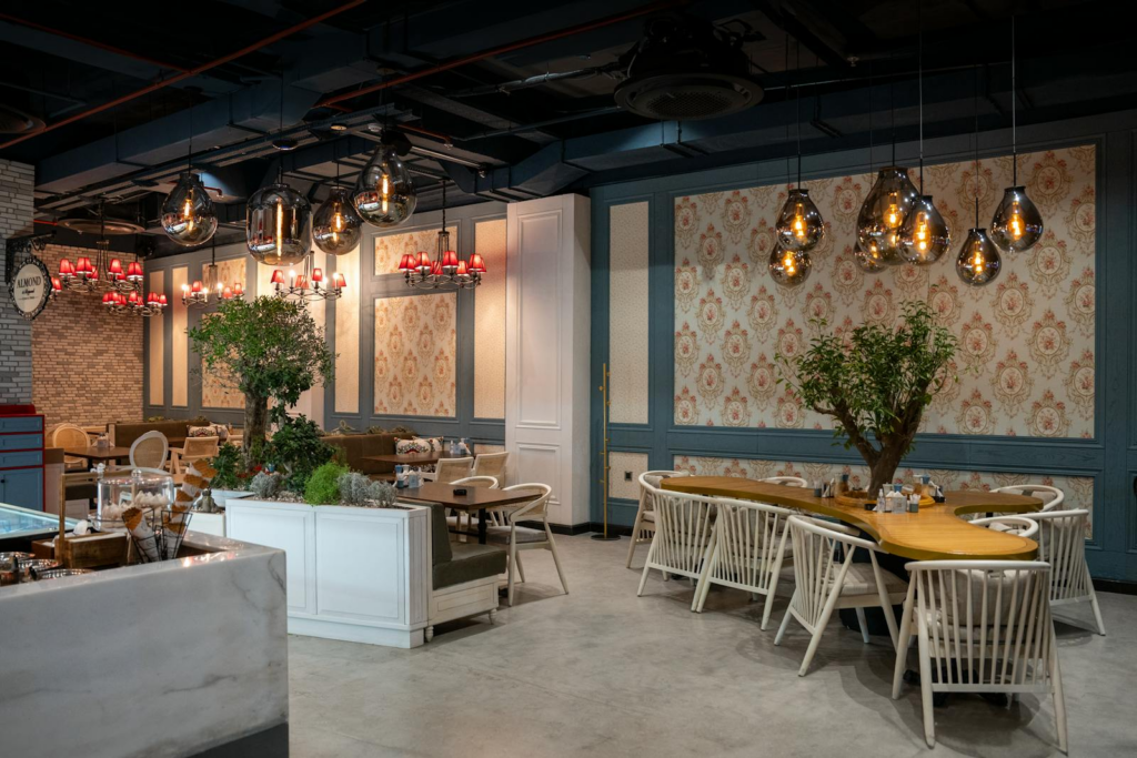 Stylish cafe interior in Erbil with modern chandeliers and elegant seating arrangement.